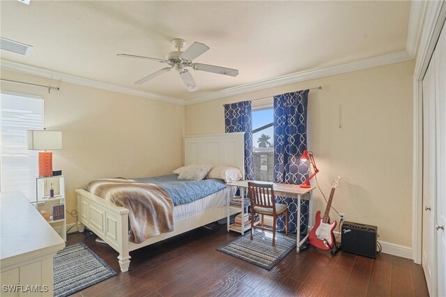 bedroom with baseboards, crown molding, a ceiling fan, and wood finished floors