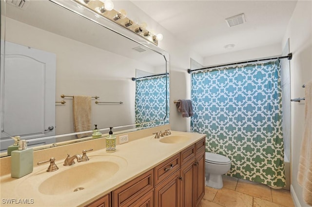 full bath featuring toilet, double vanity, a sink, and visible vents