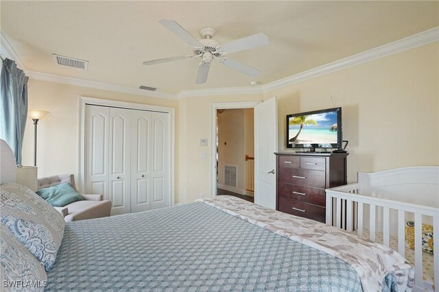 bedroom featuring a closet, visible vents, and crown molding