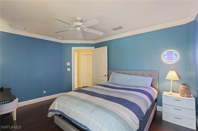 bedroom with ornamental molding, wood finished floors, visible vents, and baseboards