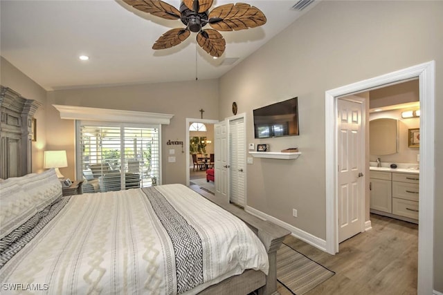 bedroom featuring lofted ceiling, ceiling fan, access to exterior, connected bathroom, and light hardwood / wood-style floors