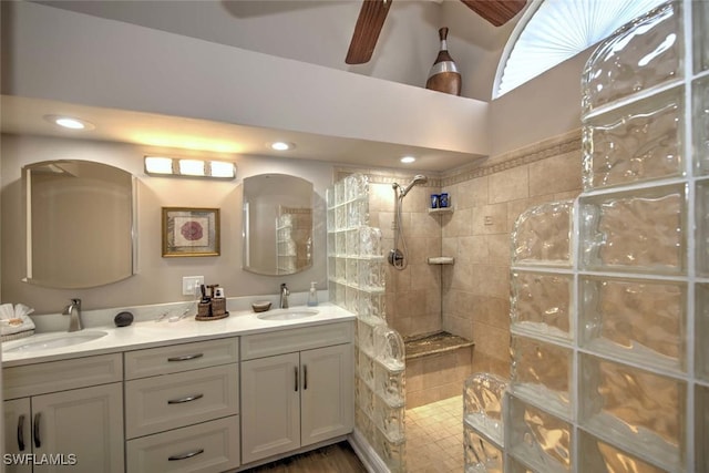 bathroom with vanity, tiled shower, and ceiling fan