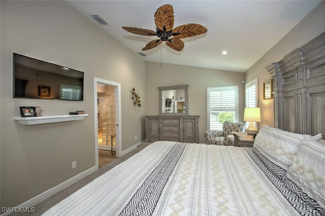 bedroom featuring ceiling fan, lofted ceiling, ensuite bath, and carpet