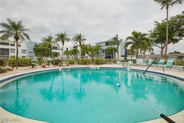 community pool featuring fence