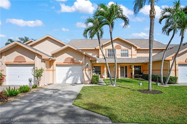 view of front of home with a garage and a front lawn