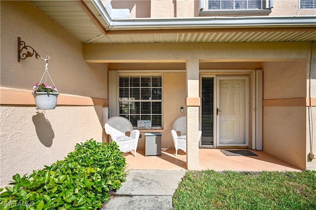 doorway to property with a patio area