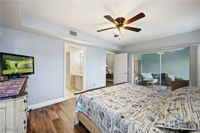 bedroom featuring ceiling fan, connected bathroom, hardwood / wood-style floors, and a closet