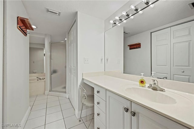 bathroom featuring tile patterned floors, separate shower and tub, and vanity