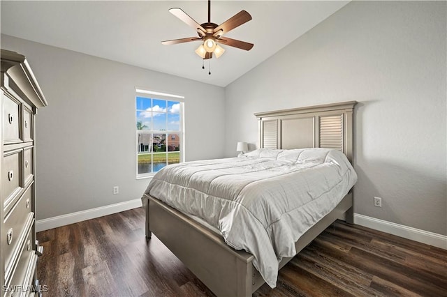 bedroom with vaulted ceiling, ceiling fan, and dark hardwood / wood-style flooring