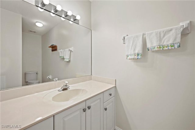 bathroom featuring vanity and toilet