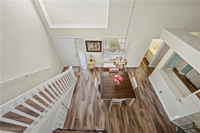 dining space with an inviting chandelier and dark hardwood / wood-style floors