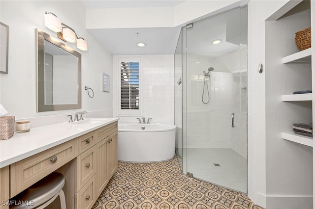 bathroom featuring shower with separate bathtub, tile patterned floors, and vanity