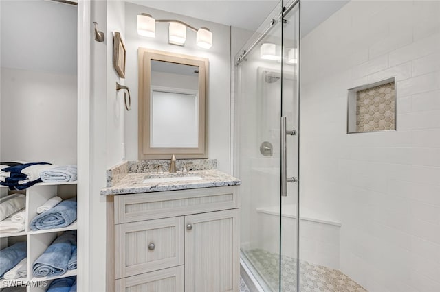 bathroom featuring an enclosed shower and vanity