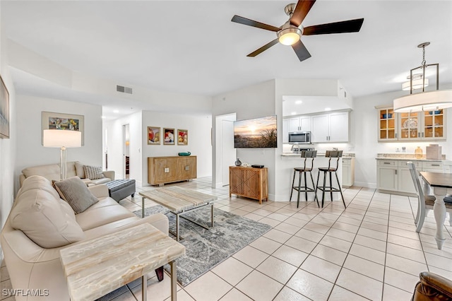 tiled living room featuring ceiling fan