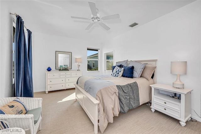 bedroom featuring light colored carpet and ceiling fan