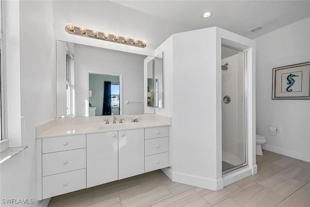 bathroom featuring walk in shower, vanity, and toilet