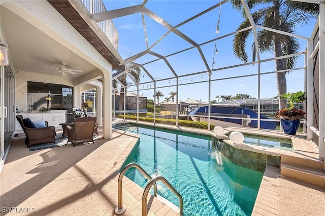 view of pool with a patio area, an in ground hot tub, ceiling fan, and glass enclosure