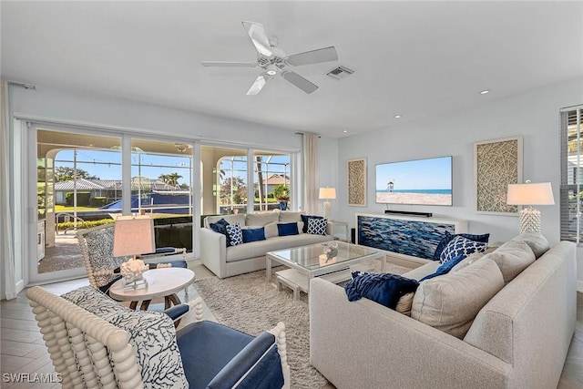 living room with ceiling fan and light wood-type flooring