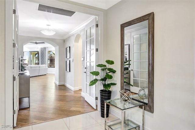 hall with crown molding and light wood-type flooring