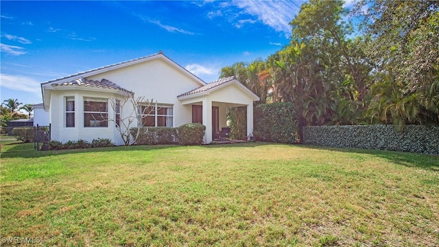 mediterranean / spanish home with a front lawn