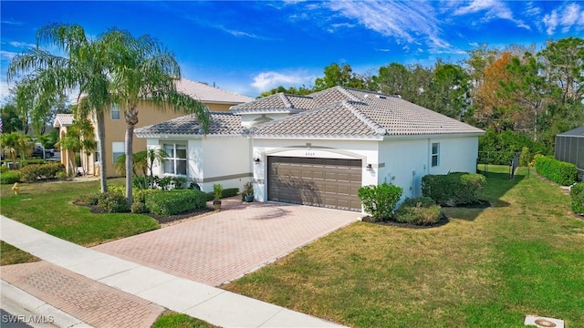 mediterranean / spanish house with a garage and a front lawn