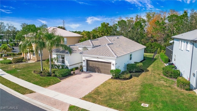 mediterranean / spanish-style house with a garage and a front yard