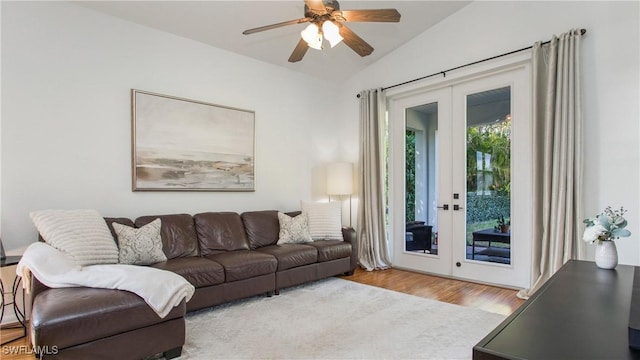 living room with french doors, ceiling fan, light hardwood / wood-style floors, and vaulted ceiling