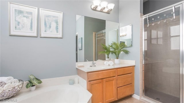 bathroom featuring tile patterned floors, vanity, and shower with separate bathtub