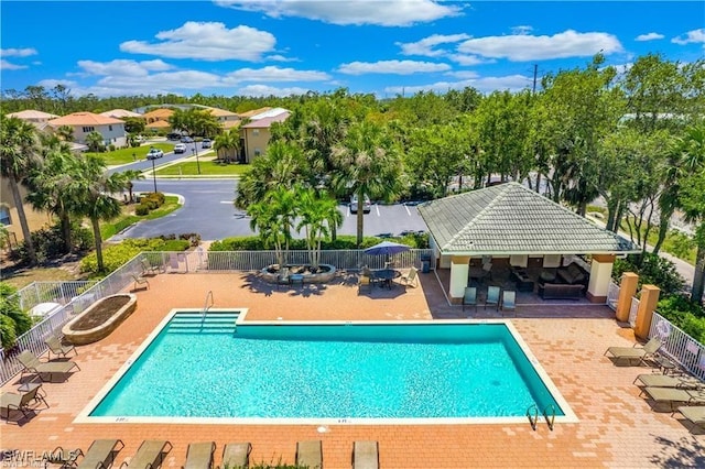 community pool featuring a gazebo, a patio area, and fence