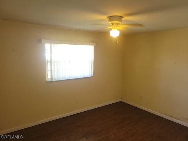 unfurnished room featuring dark hardwood / wood-style flooring and ceiling fan