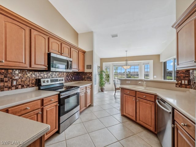 kitchen with light countertops, appliances with stainless steel finishes, visible vents, and decorative backsplash