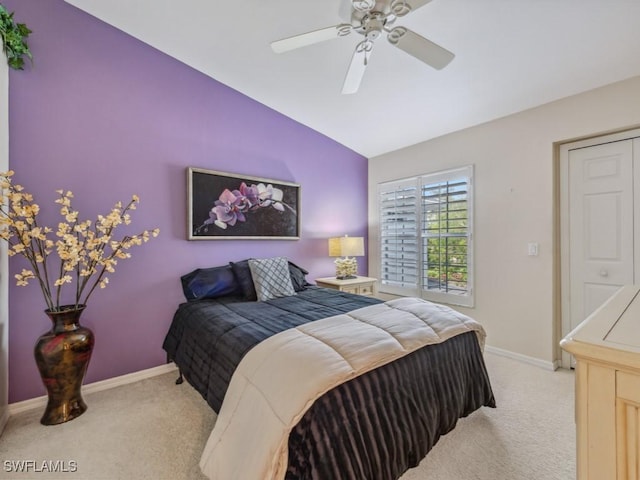 bedroom with light carpet, ceiling fan, baseboards, and lofted ceiling