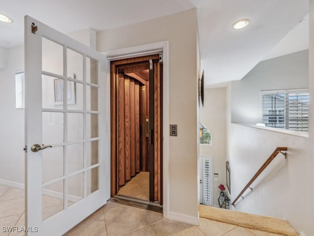 hall with lofted ceiling, recessed lighting, an upstairs landing, and tile patterned floors