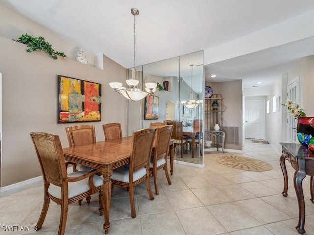 dining room featuring baseboards, arched walkways, a notable chandelier, and light tile patterned flooring