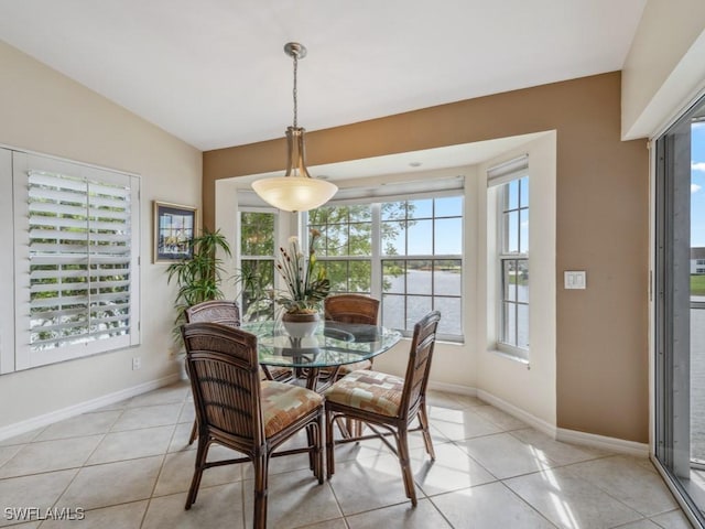 dining area with light tile patterned floors and baseboards