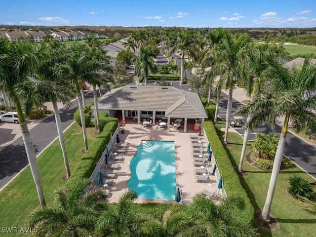 view of swimming pool featuring a residential view and a yard