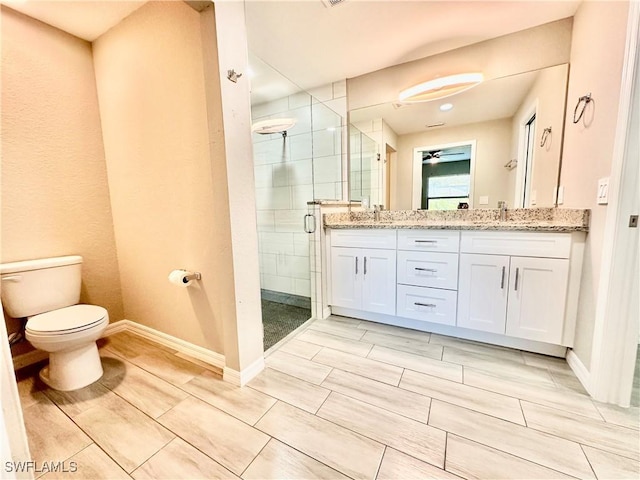 bathroom with vanity, toilet, and a shower with shower door