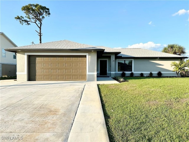 view of front of property with a garage and a front lawn