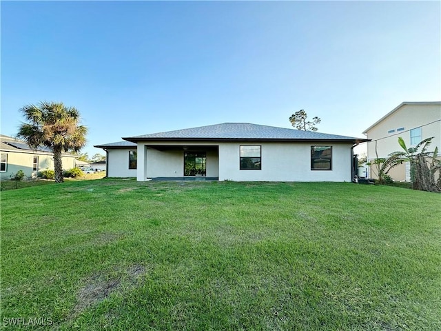 rear view of house with a yard