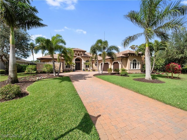 mediterranean / spanish house featuring a front lawn