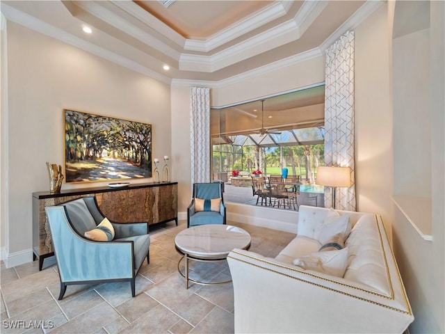 living area with crown molding and a raised ceiling