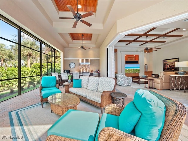 sunroom / solarium featuring a raised ceiling, coffered ceiling, ceiling fan, and beam ceiling