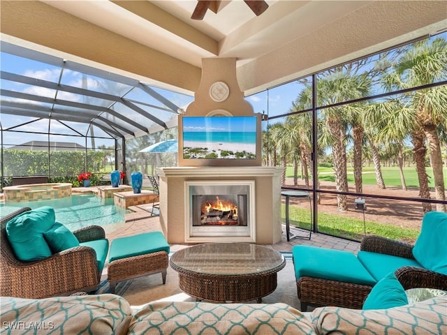 sunroom featuring ceiling fan, an outdoor fireplace, and vaulted ceiling