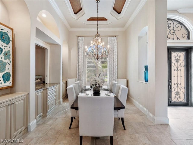 dining room featuring ornamental molding and a notable chandelier