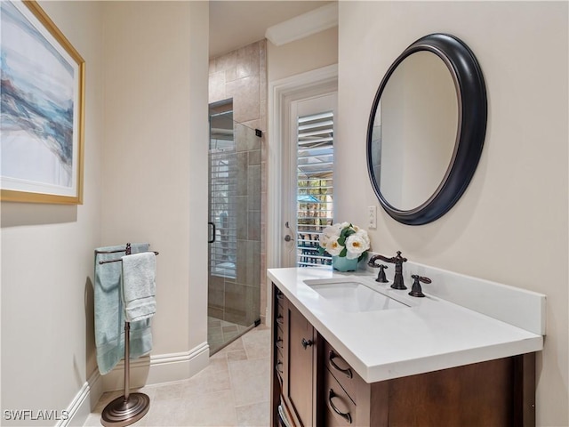 bathroom featuring a shower with door, vanity, and tile patterned floors