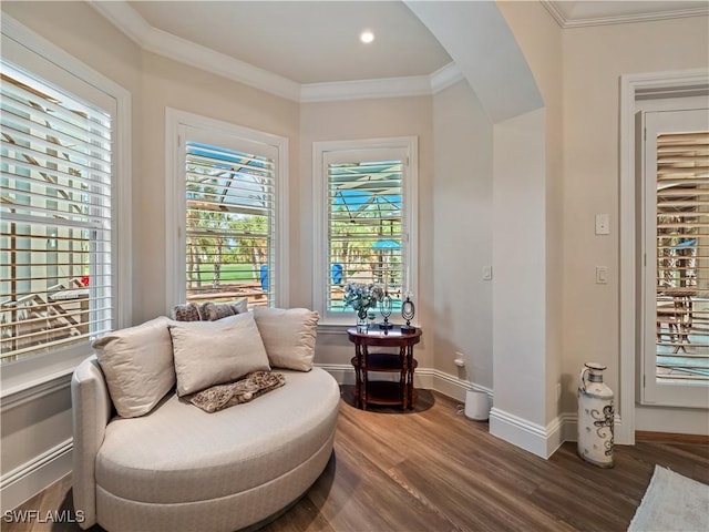 sitting room with crown molding and hardwood / wood-style flooring