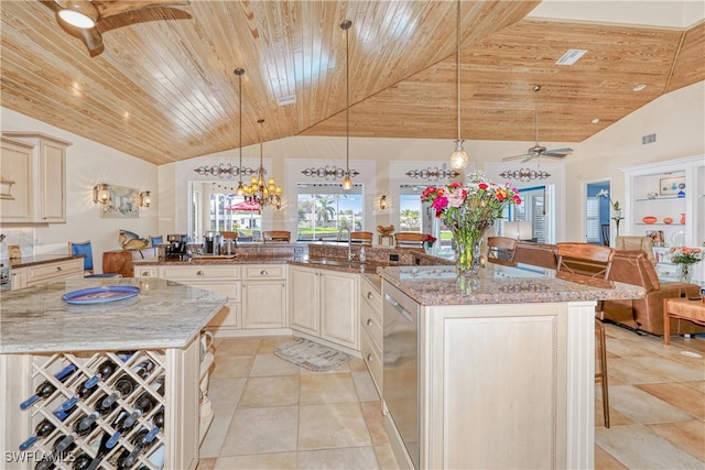 kitchen with hanging light fixtures, a center island, and light stone counters