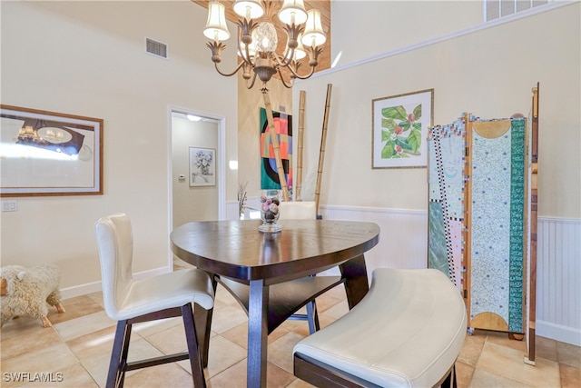 dining space with light tile patterned floors and a notable chandelier