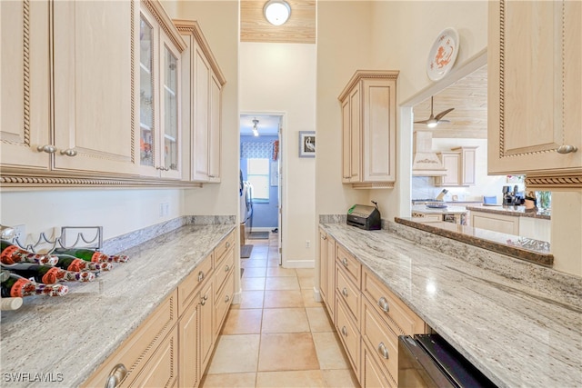 kitchen featuring light stone counters, light tile patterned floors, wood ceiling, and light brown cabinets