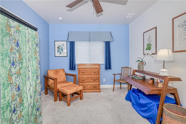 sitting room with ceiling fan and light colored carpet